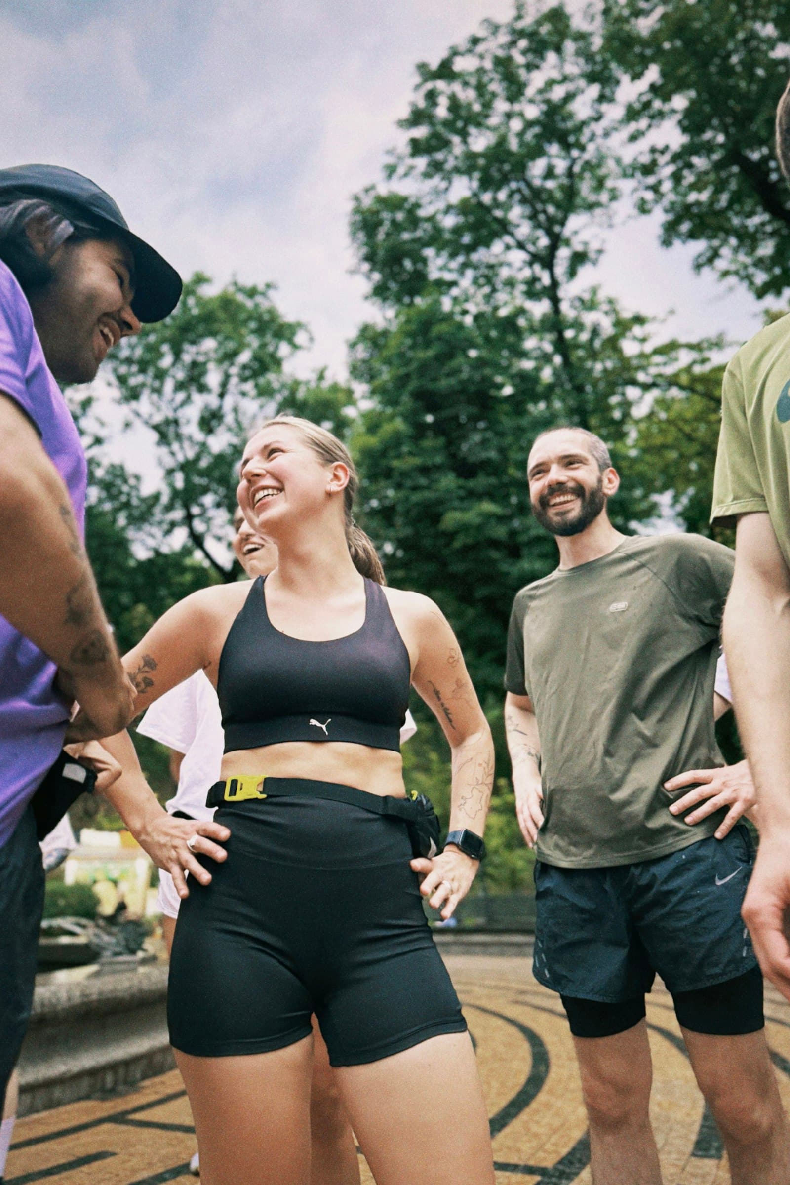 Grupo de pessoas sorrindo juntas depois de treinar em um parque